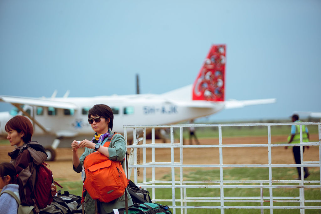 Guests with their luggage boarding a light aircraft for a bush flight
