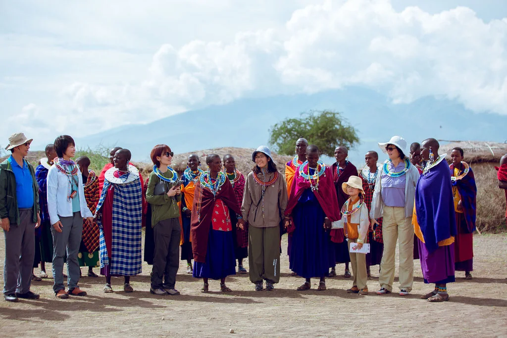 Guests standing in line with Maasai hosts at the village