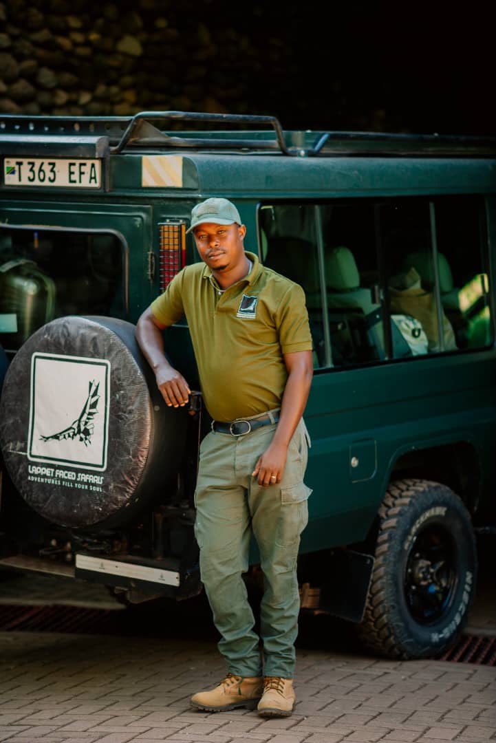 Lappet Faced Safaris driver-guide leaning against his vehicle
