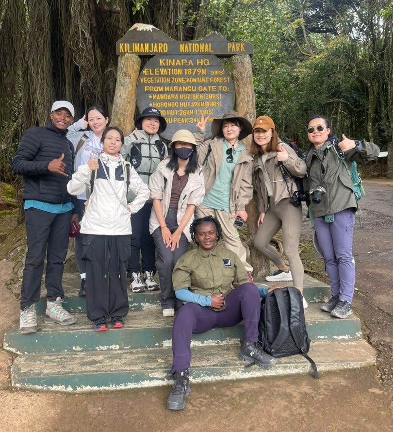 Group at the Kilimanjaro National Park headquarters sign
