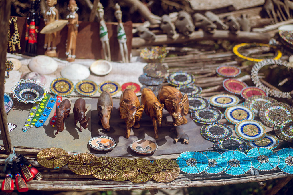 Maasai beadwork, carvings and jewellery laid out at a village stall
