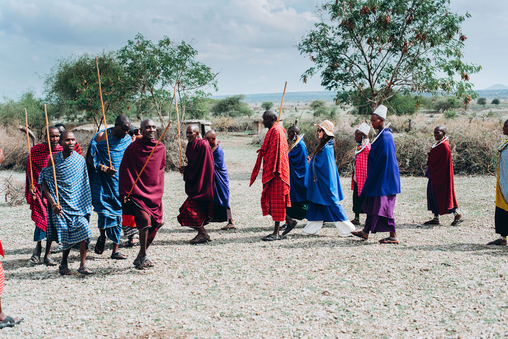 Maasai hosts walking together at their village