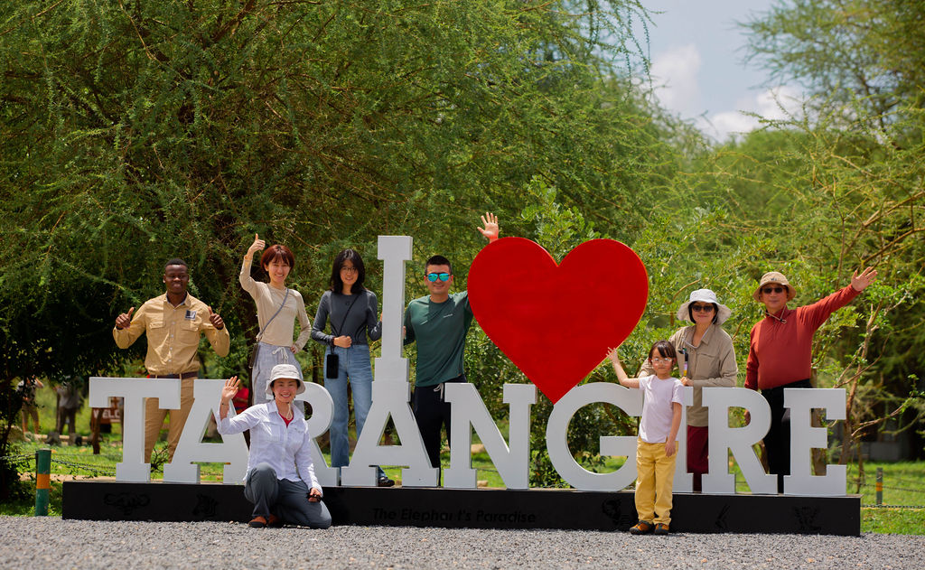Guests at the I love Tarangire sign in Tarangire National Park